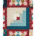 A super close up on one of the log cabin blocks, demonstrating fabric color and print details as well as top quilting effects.