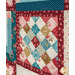 A super close up on one of the strip pieced blocks, demonstrating fabric color and print details as well as top quilting effects.