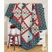 The completed Patchwork Porch quilt in ocean blue, brick red, and sandy cream fabrics from the Lighthouse collection by Andover Fabrics, artfully draped over a white armoire and staged with coordinating decor.