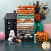 image of the Frank and Friends Fat Quarter Bundle stacked and staged with coordinating Halloween decor and thread.