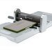 A die-cutting machine with the GO! Towel Topper positioned inside, ready for use.