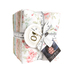 A bundle of assorted fabric squares tied with a measuring tape, featuring floral patterns and a tag.
