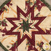 A super close up on the center of the hot pad, demonstrating fabric details on the beautiful folded star center.