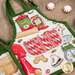 A close up on one of the apron hot pads, showing detail on the baking themed fabrics and lace trim of the dimensional pocket.