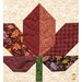 A super close up on an autumn leaf, showcasing fabric, stitching, and piecing details.