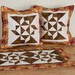 A shot of the completed Cotillion design in pillowcases and table runner.