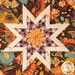 A super close up on the center of the hot pad, demonstrating fabric details on the beautiful folded star center.