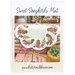 Front cover of pattern, showing the completed project on a paint faded wood and fabric background.