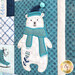 A super close up on an appliqué polar bear demonstrating fabric colors and machine embroidered details.