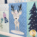 A super close up on an appliqué reindeer demonstrating fabric colors and machine embroidered details.