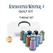 Ten spools of thread coordinating with the Enchanted Winter quilt with a clear storage box behind them, isolated on a white background underneath a text graphic that reads 