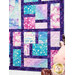 A stylized close up on the Stained Glass patchwork of the quilt, showing details on the color, print, and top quilting.