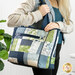 A model stands with the tote bag slung over their shoulder to showcase use and size.