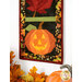 A shot of the bottom jack-o-lantern block of the project, with part of the fall leaf peeking into frame from the top. Coordinating autumnal decor sit below the project.