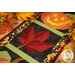 A close up on the middle leaf block, framed by decorative fall leaves on a wooden tabletop.