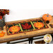 A shot of the project as a table runner, displayed horizontally on a wooden table set with coordinating autumnal decor.