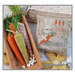 A image of the completed The Little Bunny cross stitch pattern staged with a basket of carrots. 