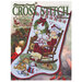 Front of cross stitch pattern book showing the main pattern' Rockin' Mrs. Claus stocking finished. 
