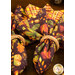 A close up on the napkins with the dark purple fabric with an autumn leaf print facing outward, wrapped in wooden napkin rings.