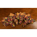 Four cloth napkins with autumnal leaf fabrics from the Autumn Fields collection by Studio E fabrics staged on a mahogany table.