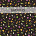 A swatch of black fabric with scattered Halloween candy motifs like ghost popsicles, candy corn, and lollipops. A transparent banner at the top read 