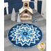 The completed Point of View Kaleidscope Folded Star Table Topper colored in wintry blue, white, and navy fabrics from the Father Christmas collection by Northcott Fabrics, staged on a rustic gray wooden table and staged with sparkling silver tree candles, a wooden church, and an icy blue deer decoration.