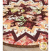 An angled super close up on the edge of the topper, showing fabric colors, prints, and top stitching details.