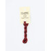 A skein of variegated red embroidery floss, twisted and bundled, with a cream and black label featuring the brand name and color information.