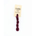 A skein of dark red embroidery floss, twisted and bundled, with a cream and black label featuring the brand name and color information.