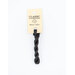 A skein of soft black embroidery floss, twisted and bundled, with a cream and black label featuring the brand name and color information.