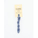 A skein of gray blue embroidery floss, twisted and bundled, with a cream and black label featuring the brand name and color information.