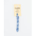 A skein of blue embroidery floss, twisted and bundled, with a cream and black label featuring the brand name and color information.