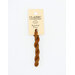A skein of cinnamon brown embroidery floss, twisted and bundled, with a cream and black label featuring the brand name and color information.