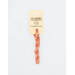 A skein of coral pink embroidery floss, twisted and bundled, with a cream and black label featuring the brand name and color information.