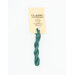 A skein of ocean blue embroidery floss, twisted and bundled, with a cream and black label featuring the brand name and color information.