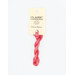 A skein of candy pink embroidery floss, twisted and bundled, with a cream and black label featuring the brand name and color information.