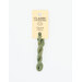 A skein of light green embroidery floss, twisted and bundled, with a cream and black label featuring the brand name and color information.