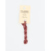 A skein of light terra cotta embroidery floss, twisted and bundled, with a cream and black label featuring the brand name and color information.