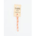 A skein of light peach embroidery floss, twisted and bundled, with a cream and black label featuring the brand name and color information.