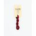 A skein of variegated red and dark red embroidery floss, twisted and bundled, with a cream and black label featuring the brand name and color information.