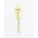 A skein of light green embroidery floss, twisted and bundled, with a cream and black label featuring the brand name and color information.
