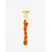 A skein of bright orange embroidery floss, twisted and bundled, with a cream and black label featuring the brand name and color information.