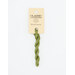 A skein of light leaf green embroidery floss, twisted and bundled, with a cream and black label featuring the brand name and color information.