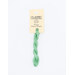 A skein of mint green embroidery floss, twisted and bundled, with a cream and black label featuring the brand name and color information.