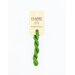 A skein of bright green embroidery floss, twisted and bundled, with a cream and black label featuring the brand name and color information.