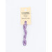 A skein of light purple embroidery floss, twisted and bundled, with a cream and black label featuring the brand name and color information.