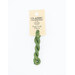 A skein of green embroidery floss, twisted and bundled, with a cream and black label featuring the brand name and color information.