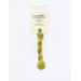 A skein of bright green embroidery floss, twisted and bundled, with a cream and black label featuring the brand name and color information.