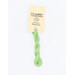 A skein of spring green embroidery floss, twisted and bundled, with a cream and black label featuring the brand name and color information.