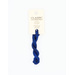 A skein of navy blue embroidery floss, twisted and bundled, with a cream and black label featuring the brand name and color information.